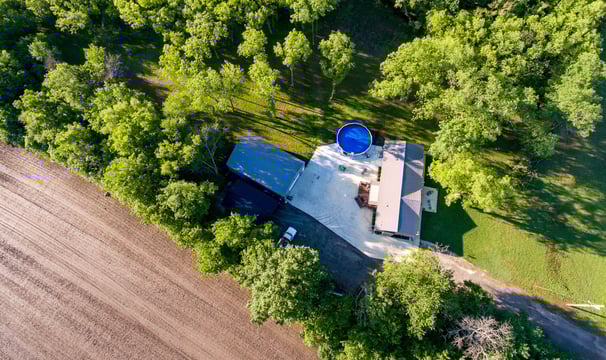 a house with a blue water tank and a blue bucket