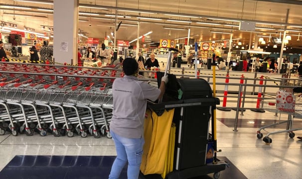 a woman pushing a carton in a store