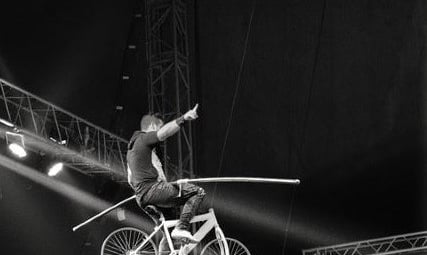 équilibriste à velo sur un fil, photographie noir et blanc