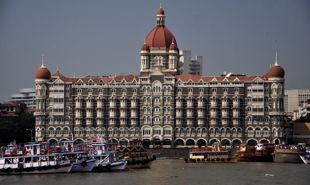 An image showing the Taj Mahal Palace hotel at its grand opening, capturing the building’s early architectural charm.