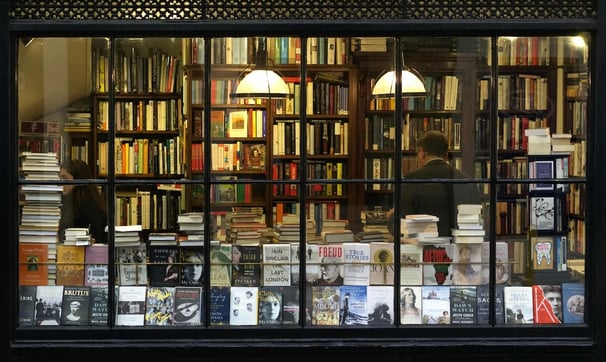 Books on Longevity - a book storefront window with a bookcase and a clock