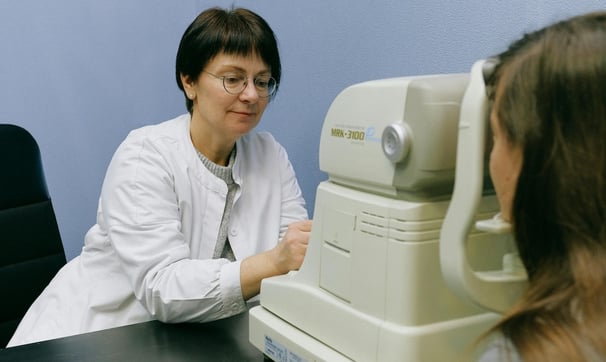 Virtual reality and Longevity - a woman in a white lab coat is looking at a patient