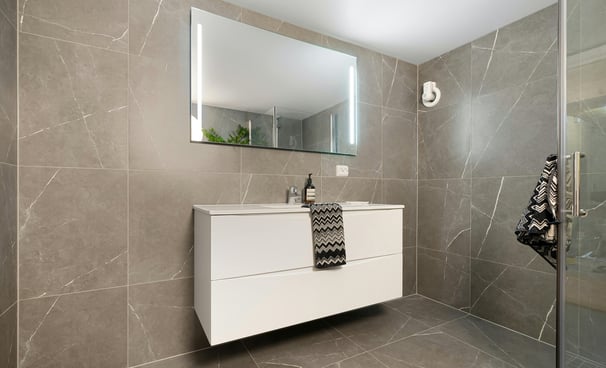 a bathroom with a white sink and a mirror