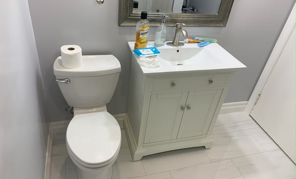 a bathroom with a toilet and a toilet paper roll