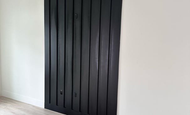 Interior door remodeling project featuring new white panel doors and black matte handles in resident