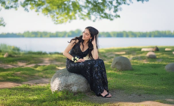 Girl's portrait on a rock near the lake on a sunny day