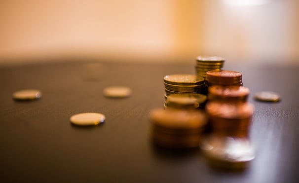 a stack of coins and coins sitting on a table