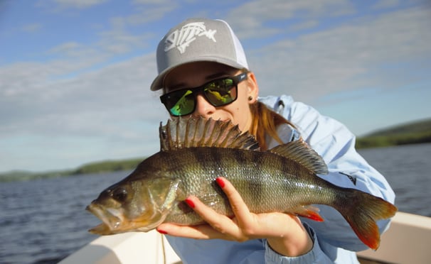 Girl angler displaying her perch catch.