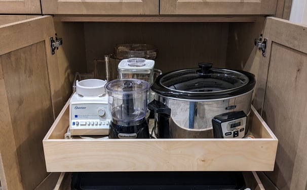 Kitchen pull out shelf holding appliances.