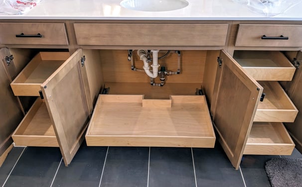 Pull-out shelving installed in a bathroom vanity.