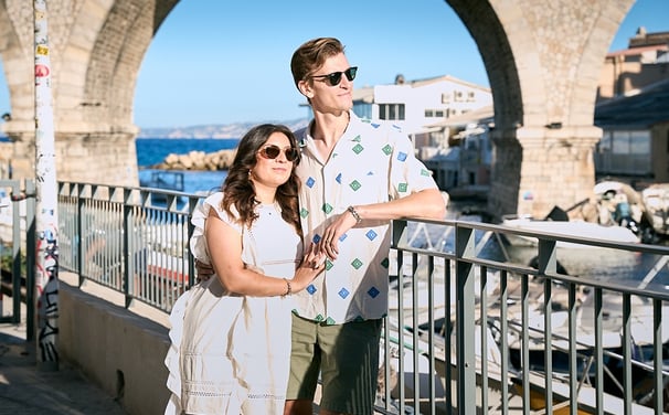 Relaxed couple portrait at Vallon des Auffes with fishing boats and iconic bridge