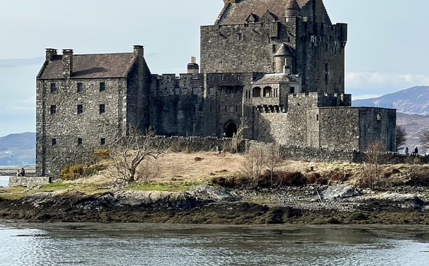 Castle in the day with water and countryside around