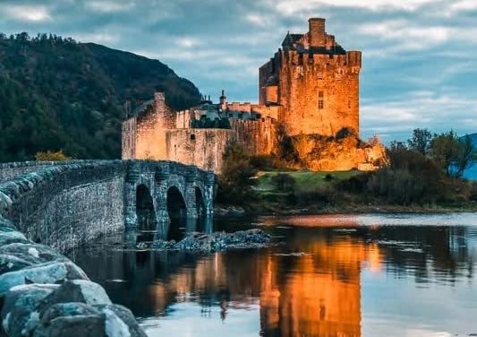 Castle at dusk with lights showing off the beautiful walls