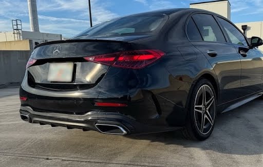 Rear view of black Mercedes C300 luxury sedan with LED tail lights