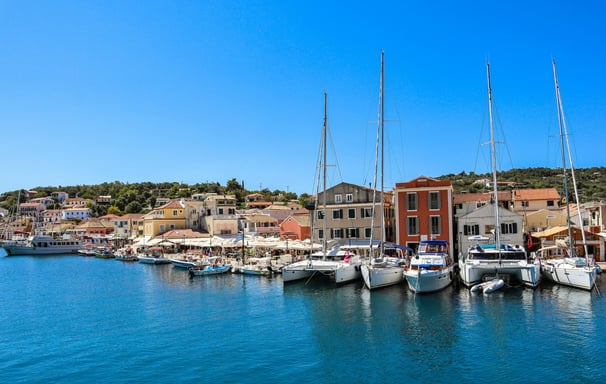 a harbor with boats and buildings in the background