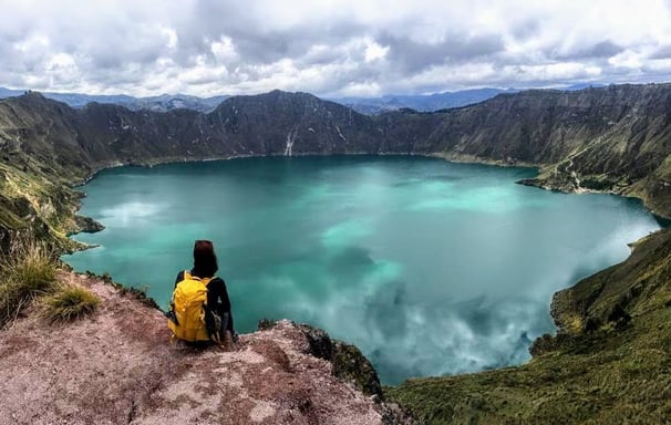 hiker admiring Quilotoa crater lake