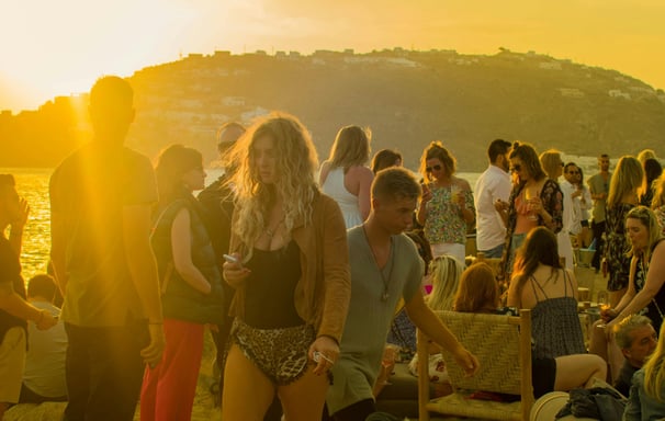 a group of people standing around a table