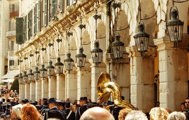 a group of people in uniform marching through a city