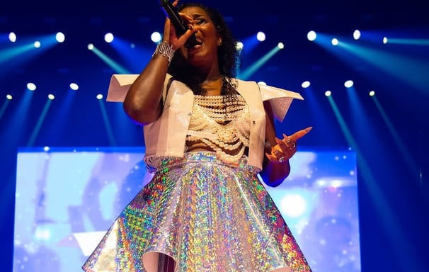 a woman in a white dress and a microphone