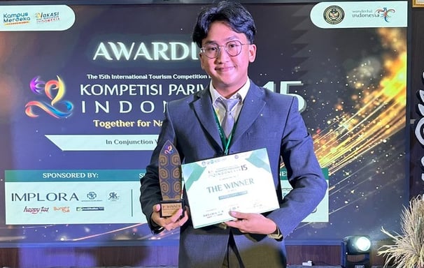 a man in a suit and tie holding a plaque