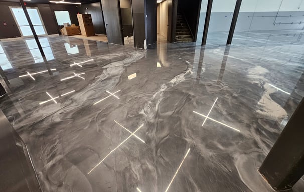 silver, black, and white metallic epoxy flooring in a showroom