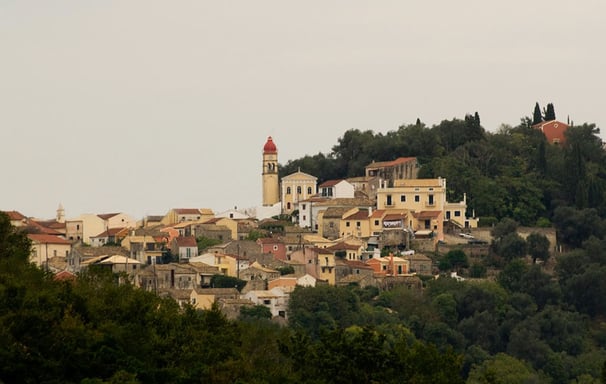 a hill with a church and a clock tower