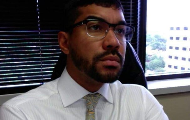 a man in a white shirt and tie dye on a tie
