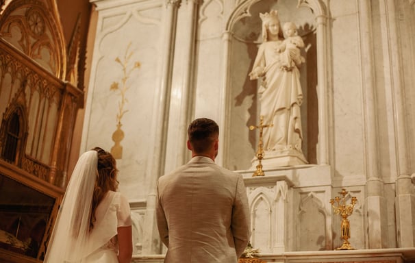 les mariées de dos à l'église durant la cérémonie du mariée face à l'autel