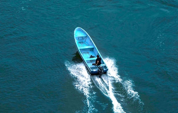 a boat with a blue and white boat in the water