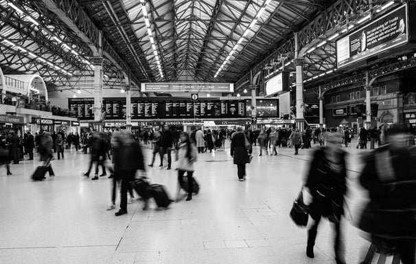a group of people walking through a train station