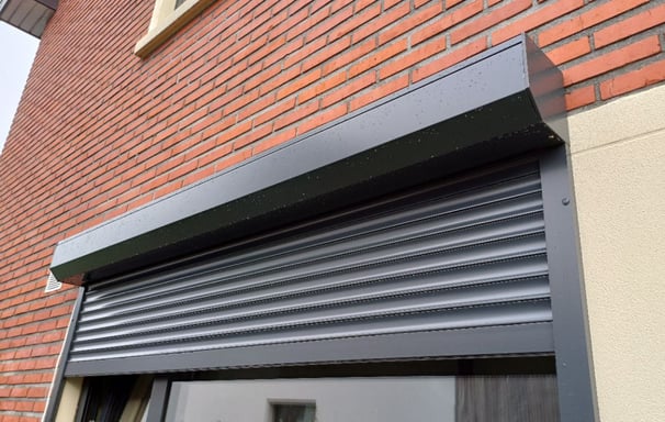 a window with a roller shuttered door and a window with a window