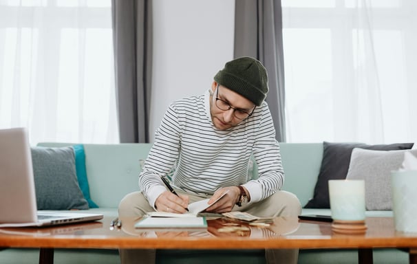 man working on a budget in his living room