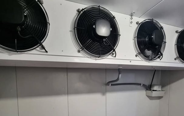 Massive industrial evaporators mounted on the ceiling of the cold room for high-capacity