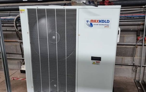Maxx Cold split cooling unit mounted in a refrigerated storage room, providing precise temperature
