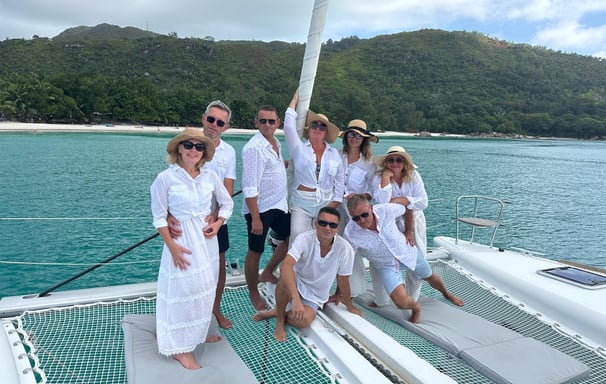 A group of friends celebrating a successful fishing trip on a catamaran