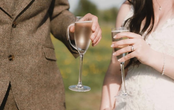 Bride and Groom share a glass of champagne