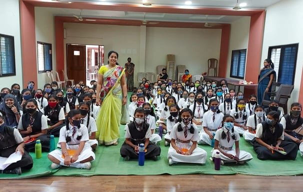 a group of children and adults in school uniforms