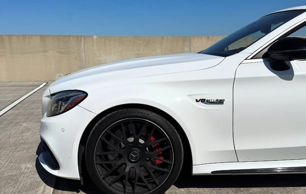 White Mercedes C63s side profile with black AMG wheels