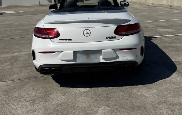 Back view of Mercedes C63s convertible showing AMG badging and quad exhausts