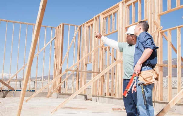 a man in a construction site with a construction worker