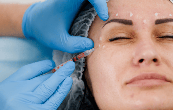 a woman getting a botoxoxation in a beauty salon