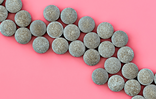 a curved stone wall with a curved line of pebbles