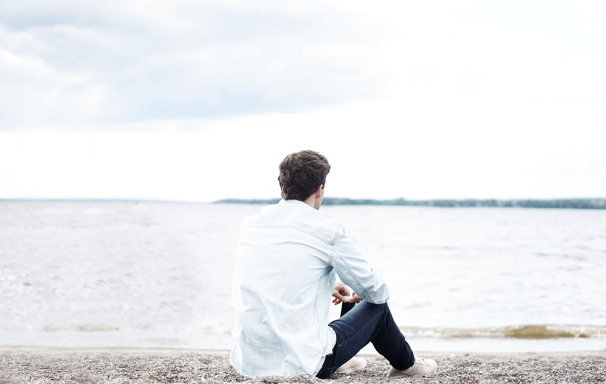 Young man sitting on the beach