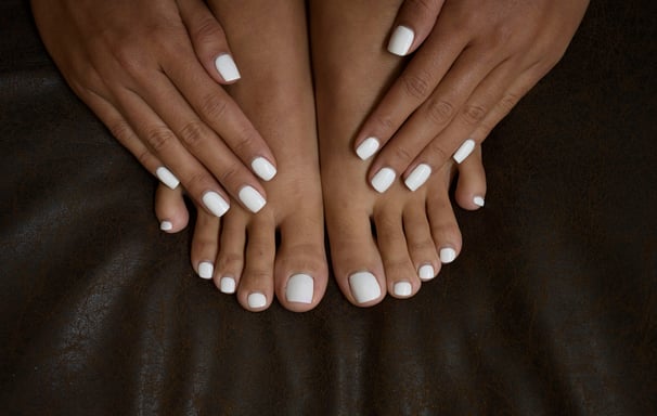 a woman's feet with white nails and white nails
