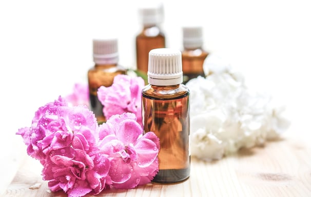 a bunch of flowers and bottles of essential oils