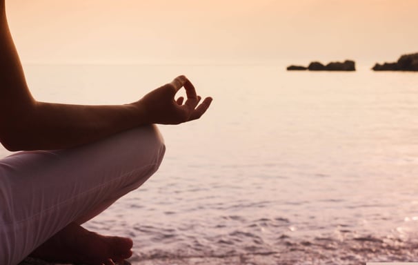 Meditation in a serene environment by the water - Holistic Health Company