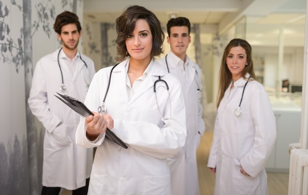 a group of doctors and nurses in white coats and lab coats