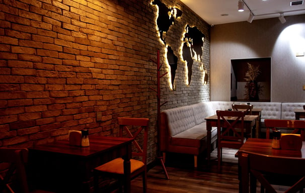 a restaurant with a brick wall and a couch