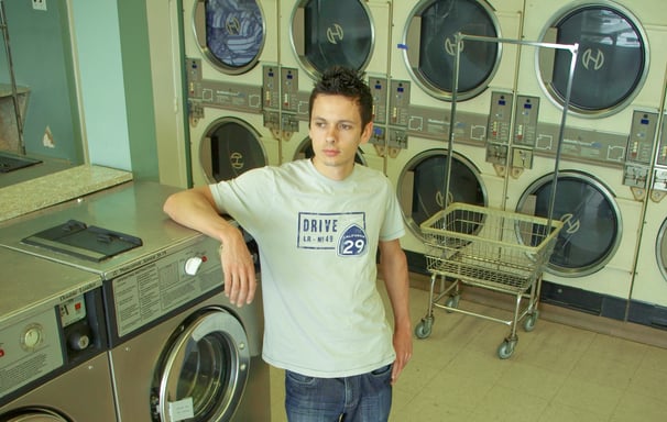 a man standing in front of a laundry machine
