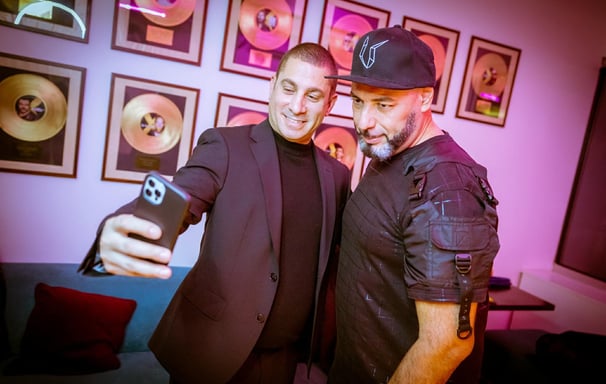 J Sassen with Roger Sanchez standing next to each other in a room